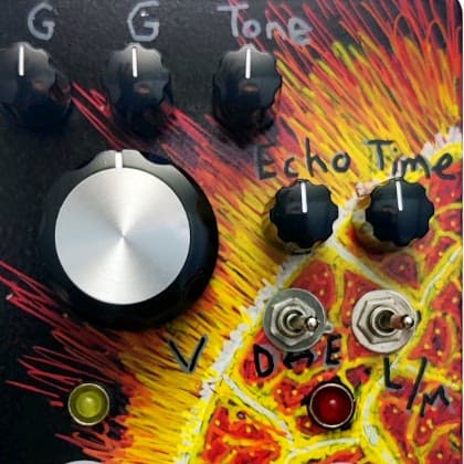 A black pedal with a hand-painted exploding sun seen from a low angle